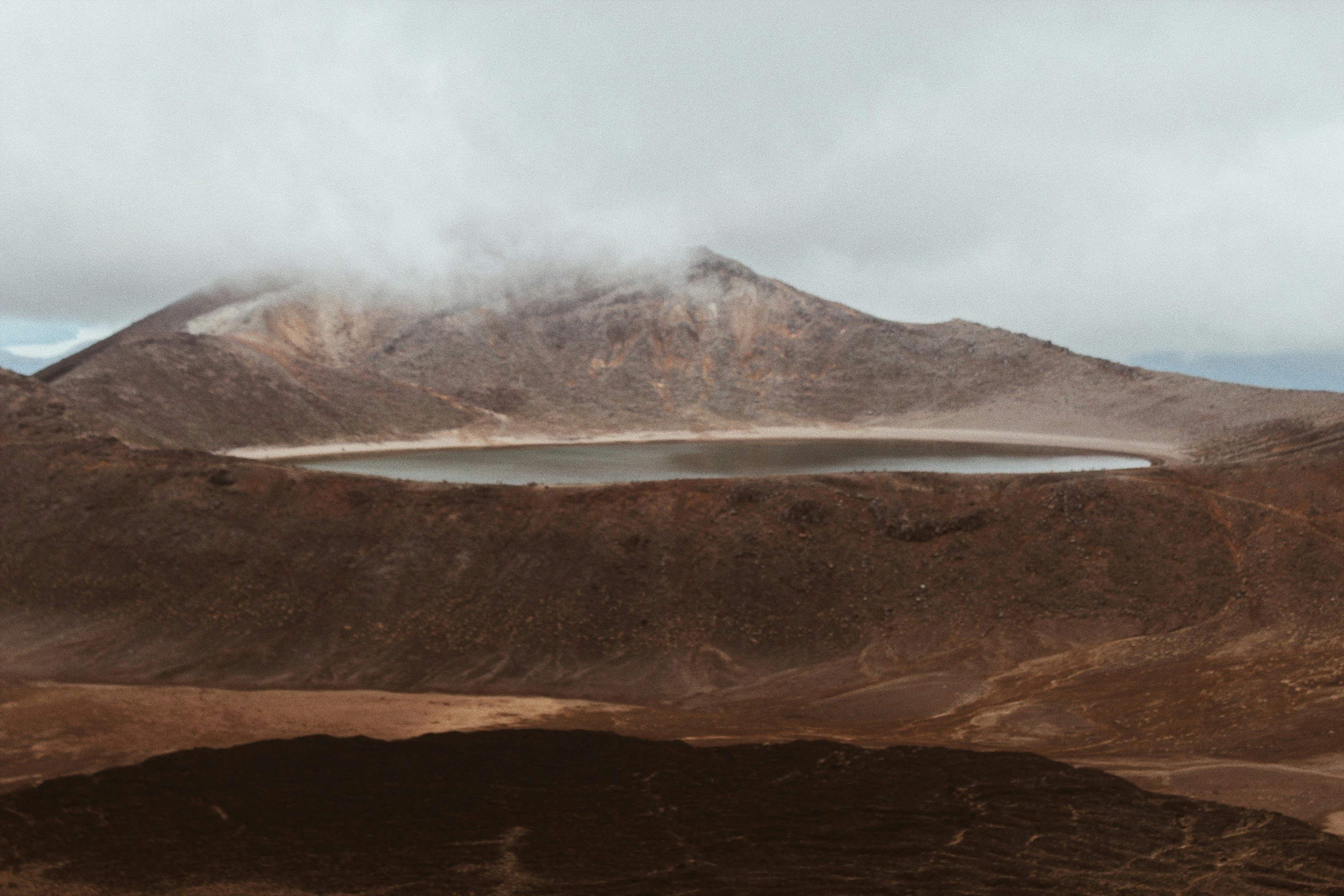 brown mountain under white clouds during daytime